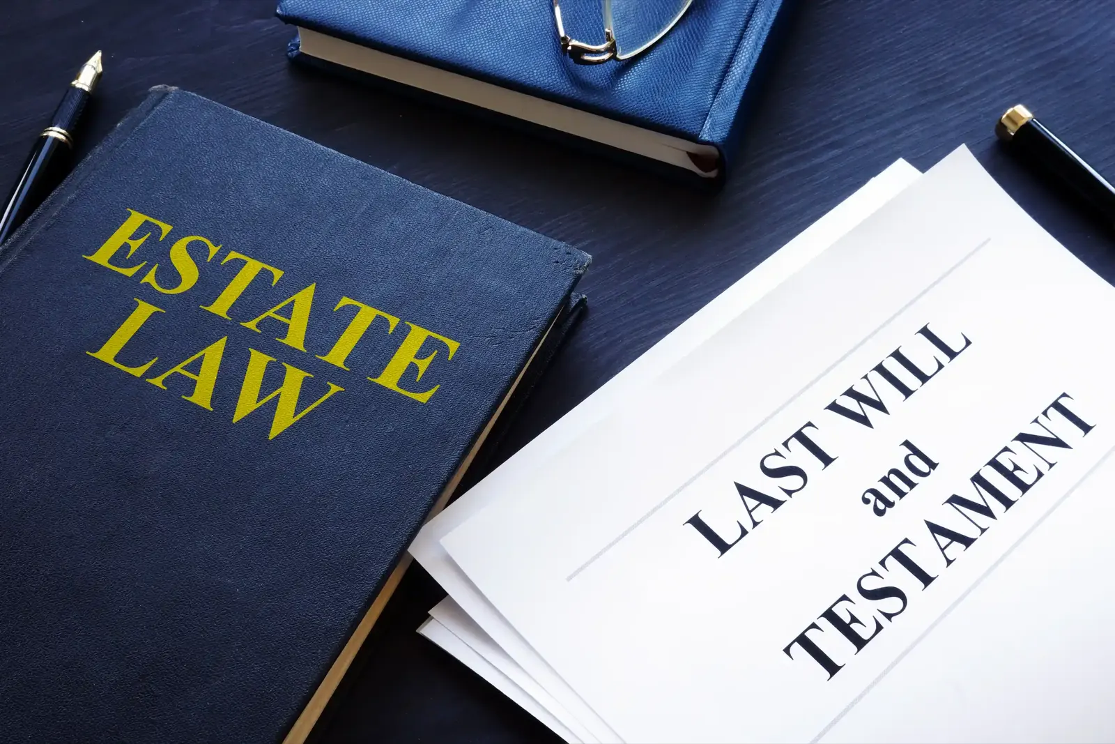 An estate law book beside a last will and testament